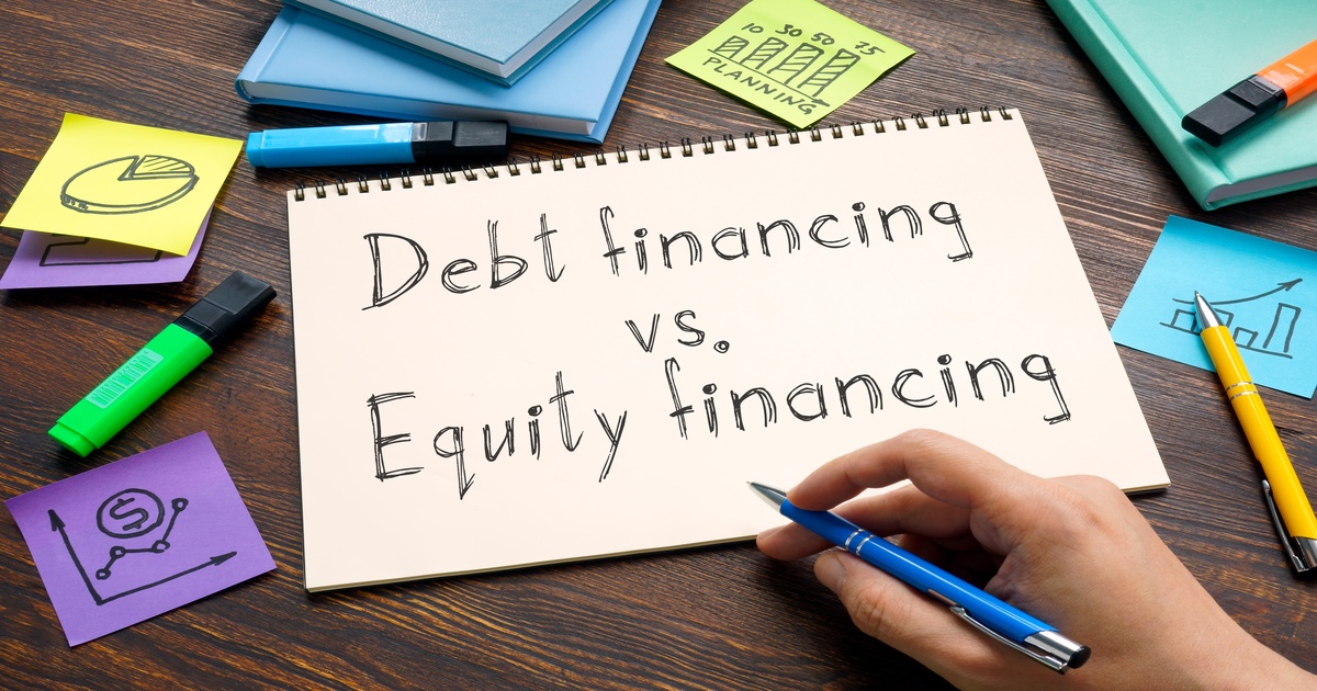 Debt financing vs equity financing text on paper